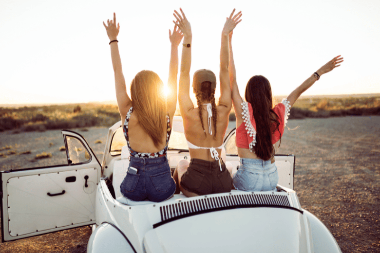 Girls in Car with Hands Up